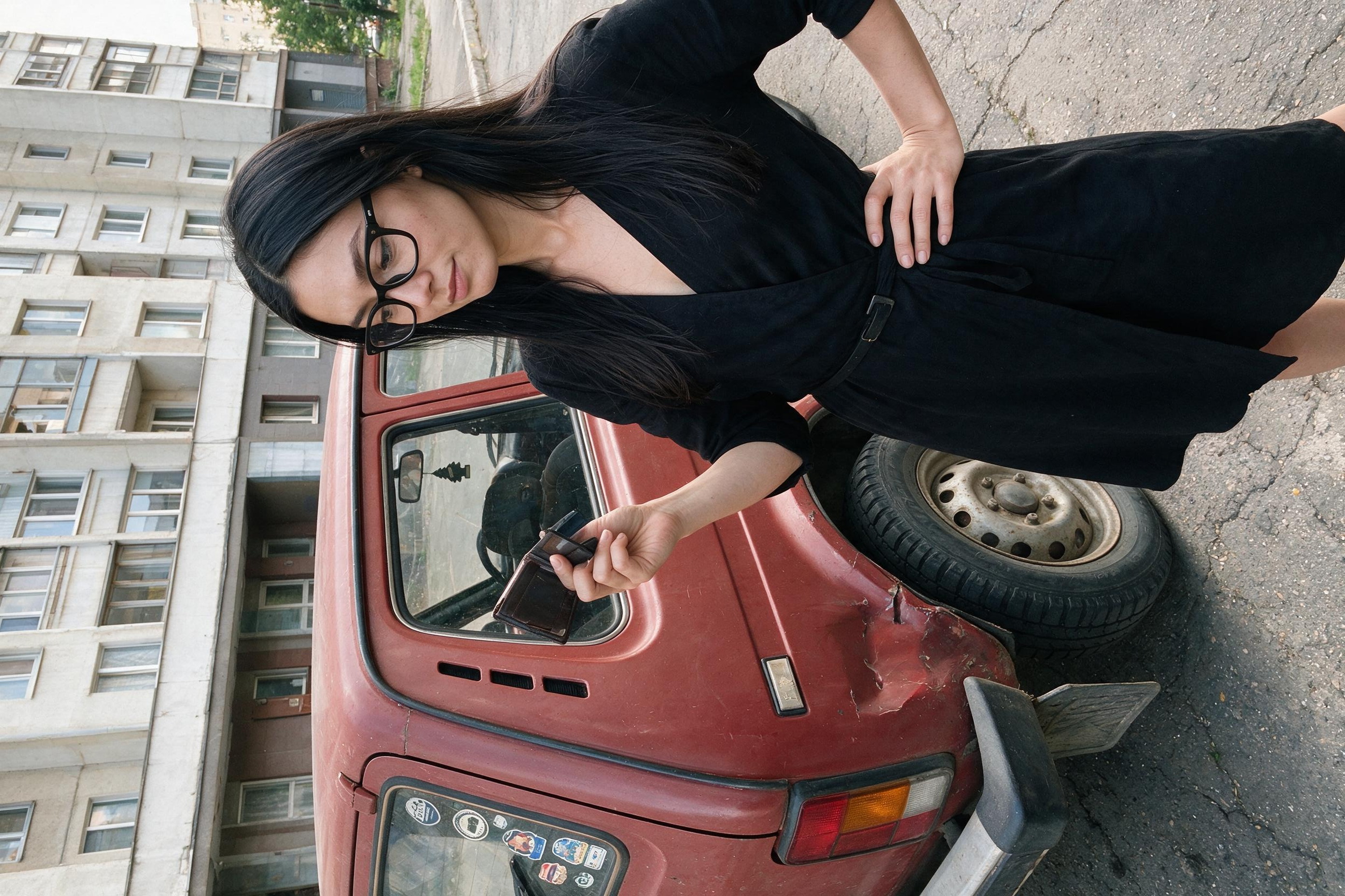 Me beside the red Niva holding an open, empty wallet.