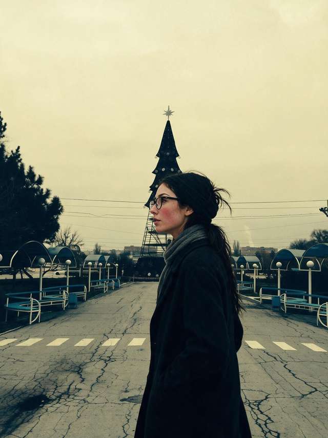 Me crossing the cracked empty street toward the steel armature of the municipal Christmas tree.