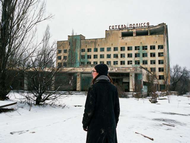 Me small on the snowy plaza before the abandoned Hotel Polissya.