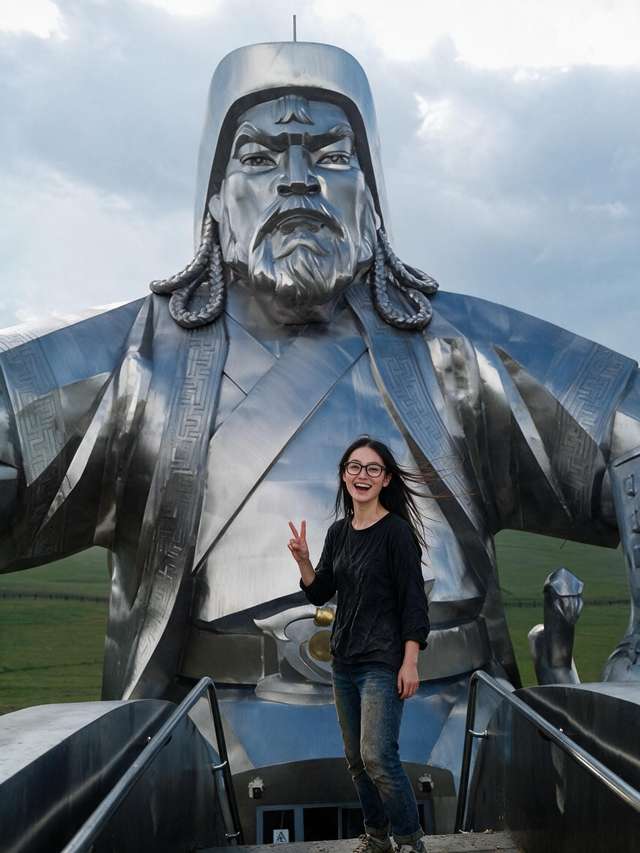 Me laughing at the railing in the mane of the giant steel horse, steppe far below.